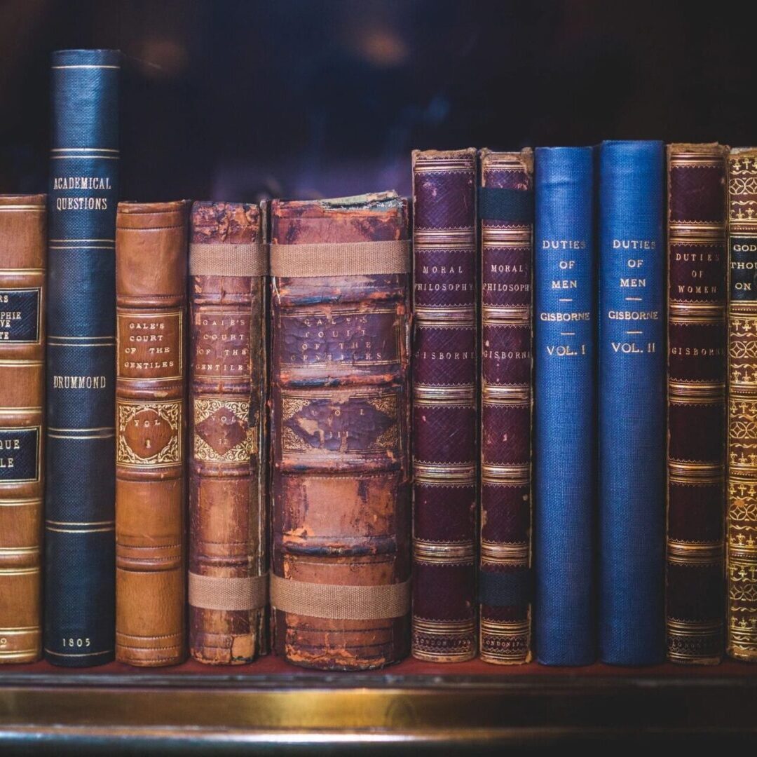 Shelf of hard-cover books of different sizes